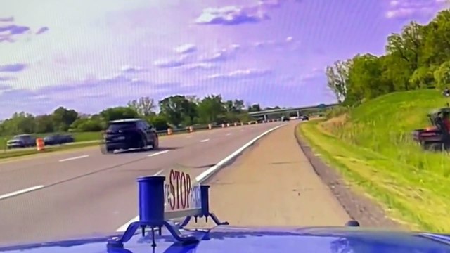 Real-life cowboy on horseback chases down and lassoes runaway cow sprinting down busy highway