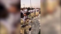 Monroe High School football players kneel during National Anthem