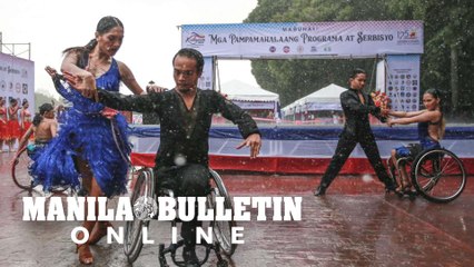 Despite persistent rain, Dancers perform at the opening of the 125th Philippine Independence Day celebration