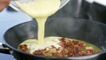 Mixing Heavy Cream To A Frying Bacon Bits To Make A Sauce