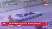 Otomobilin tavanına çıkıp dans etti