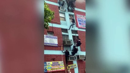 Students forced to climb down ropes to escape a burning building