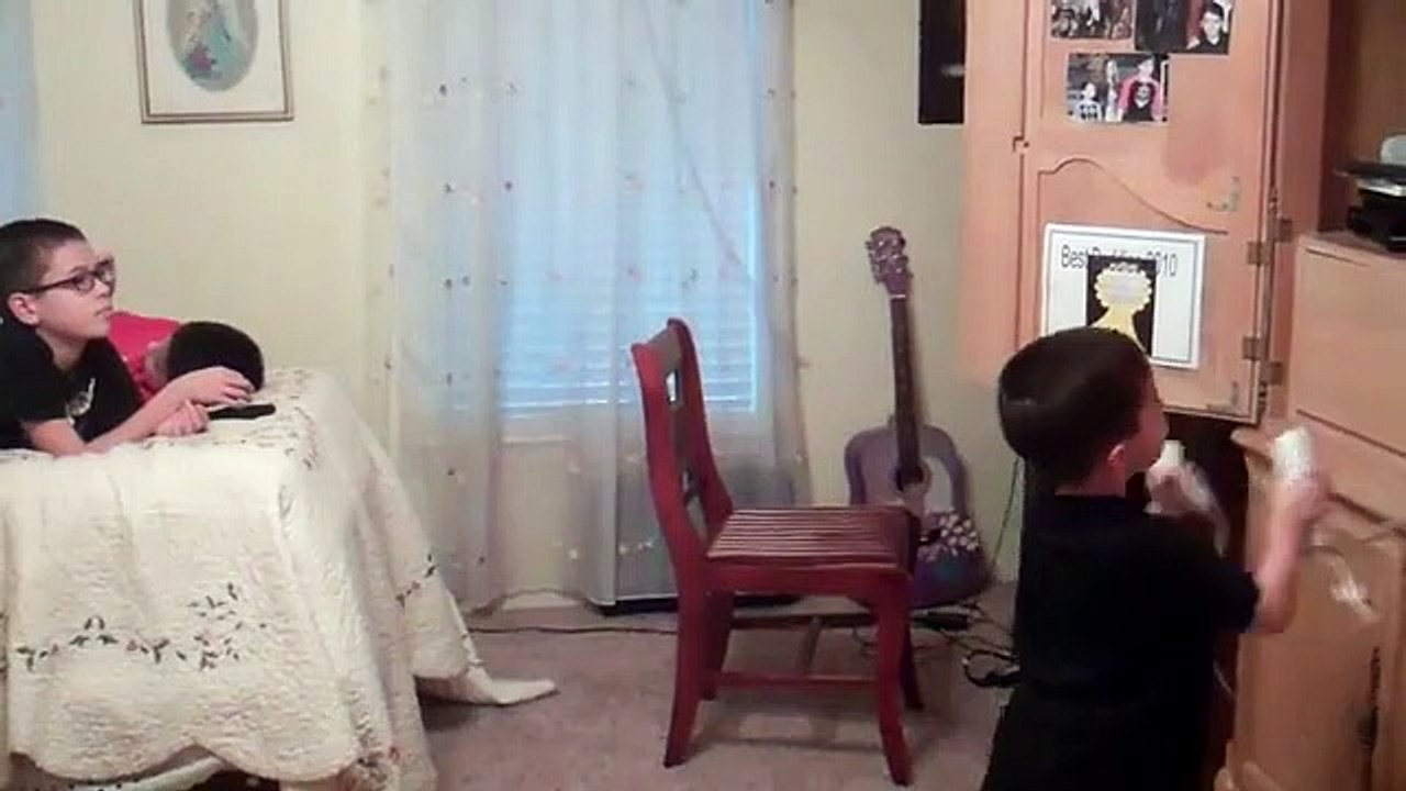 Anthony playing the wii while Jonathan & Christopher play on their phones