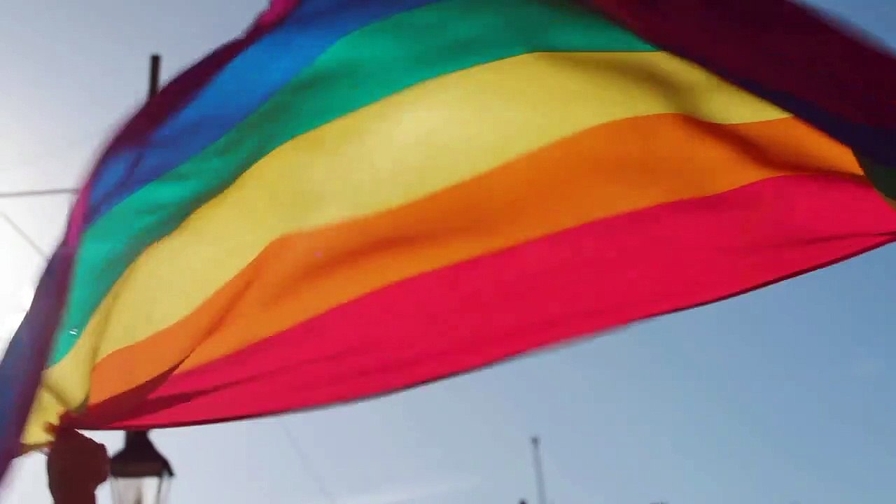 Two Men Holding Rainbow Flag