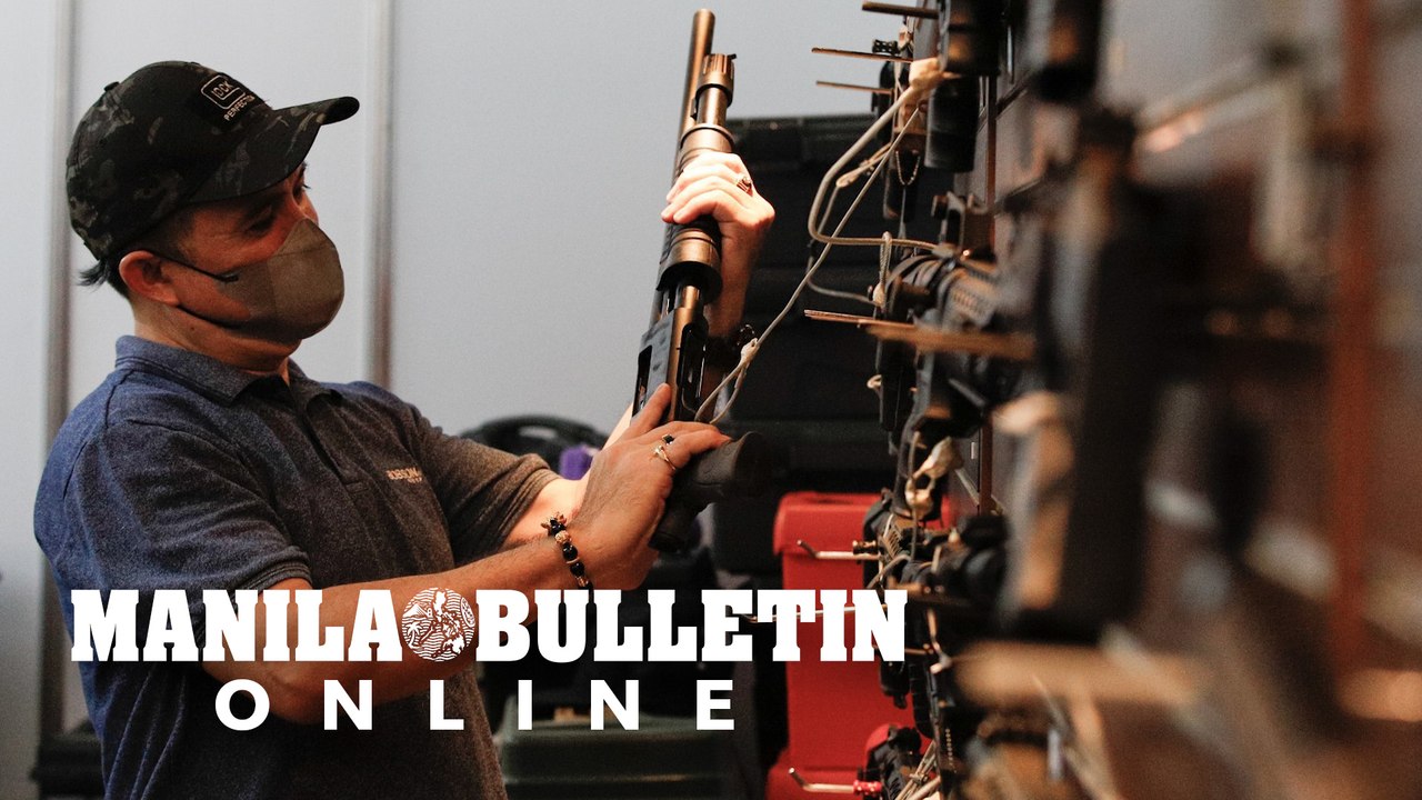 Gun enthusiasts scout for fire arms displayed a...