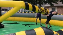 Boy gets hit on face playing on the inflatable rotating obstacle game *Hilarious Fail*