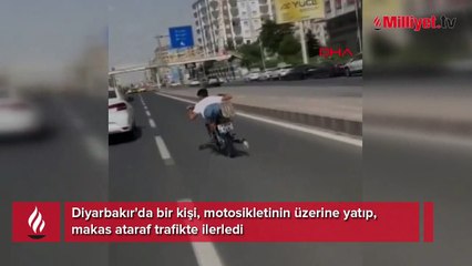 Yüzüstü uzanıp kullandığı motosikletle makas attı