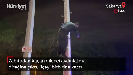 Zabıtadan kaçan dilenci aydınlatma direğine çıktı, ilçeyi birbirine kattı