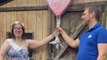 Parents-to-be glowing with happiness while doing a cute gender reveal of their twins