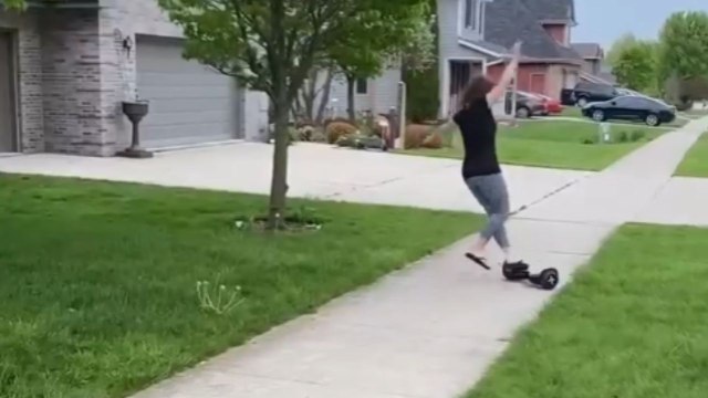 Woman takes hilarious tumble while trying to show off her hoverboarding skills to friends