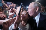 Vladimir Putin greets the public and poses for SELFIE