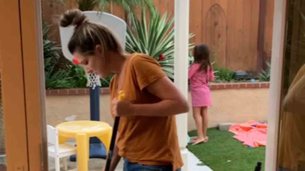Clumsy mom almost takes daughter out with a broom before falling down herself