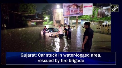 Gujarat: Car stuck in water-logged area, rescued by fire brigade