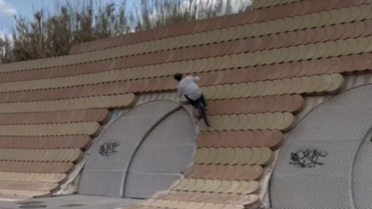 Biker flexes his awesomeness with gravity-defying wall ride & bottle-opening wizardry