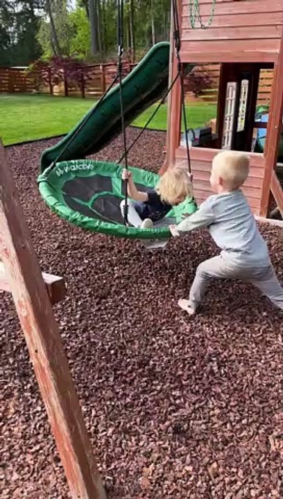Siblings Play on Swing Set