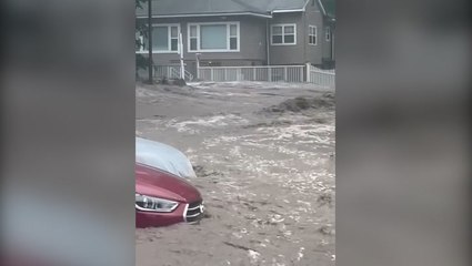 New York: Water gushes through streets as storm causes flash flooding