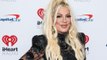 Tori Spelling moves into a motel with her five kids, but says it's not because of her alleged split from Dean McDermott