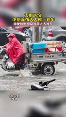 大雨中，女兒幫爸爸推車，跌倒了繼續起來推。真是好孩子！In the heavy rain, the daughter helped father push the cart,What a good girl!