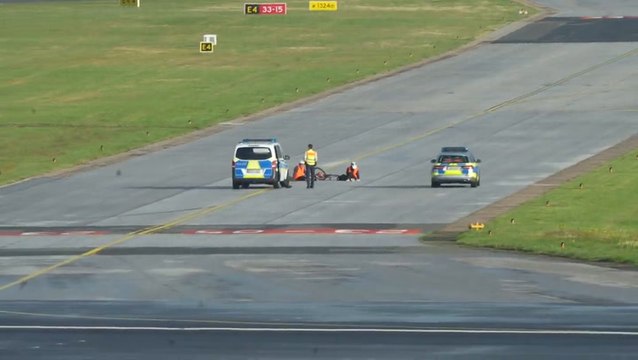 Climate activists glue themselves to runway at German airport on first day of school holidays
