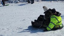 Sledding couple sliding down an unsafe hill feels the thrill... and then a BAM!