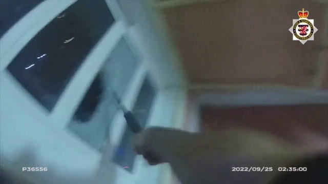 Watch: Dramatic moment men hanging from burning building rescued by firefighters and police officer