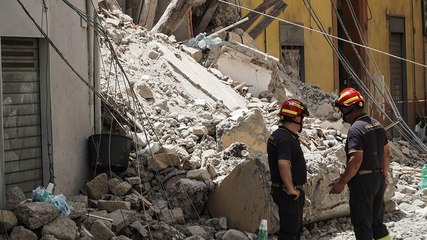 Firefighters clear rubble after building collapses in Naples