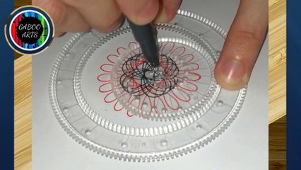 DIBUJANDO con un espirógrafo una flor de pétalos rojos y centro negro. DRAWING with a spirograph a flower with red petals and a black center.