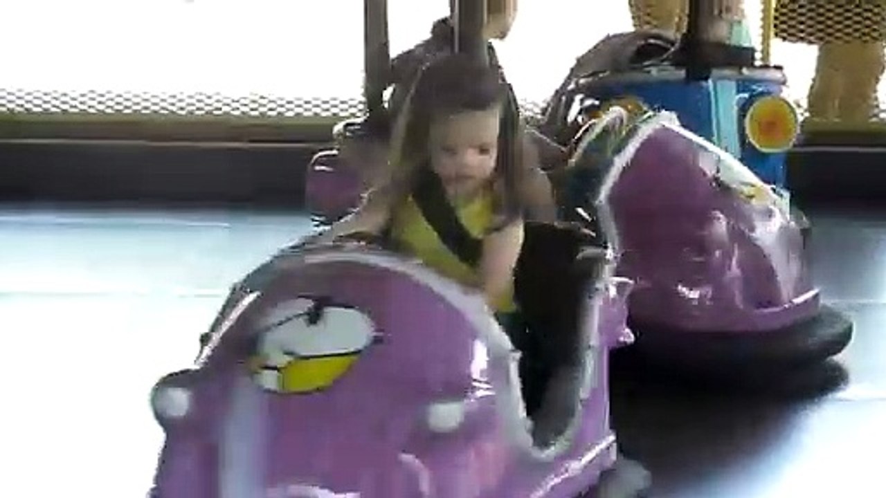 Little girl driving Bumper Car, watch and enjoy.