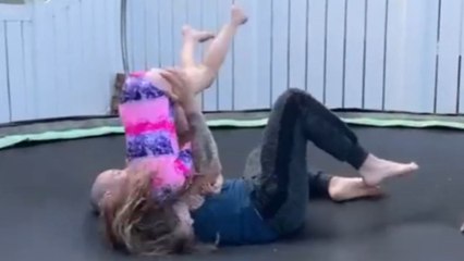 Girl makes good on her Jiu Jitsu training by surprising dad with a headlock