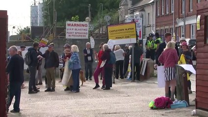 Protesters gather as migrant barge arrives