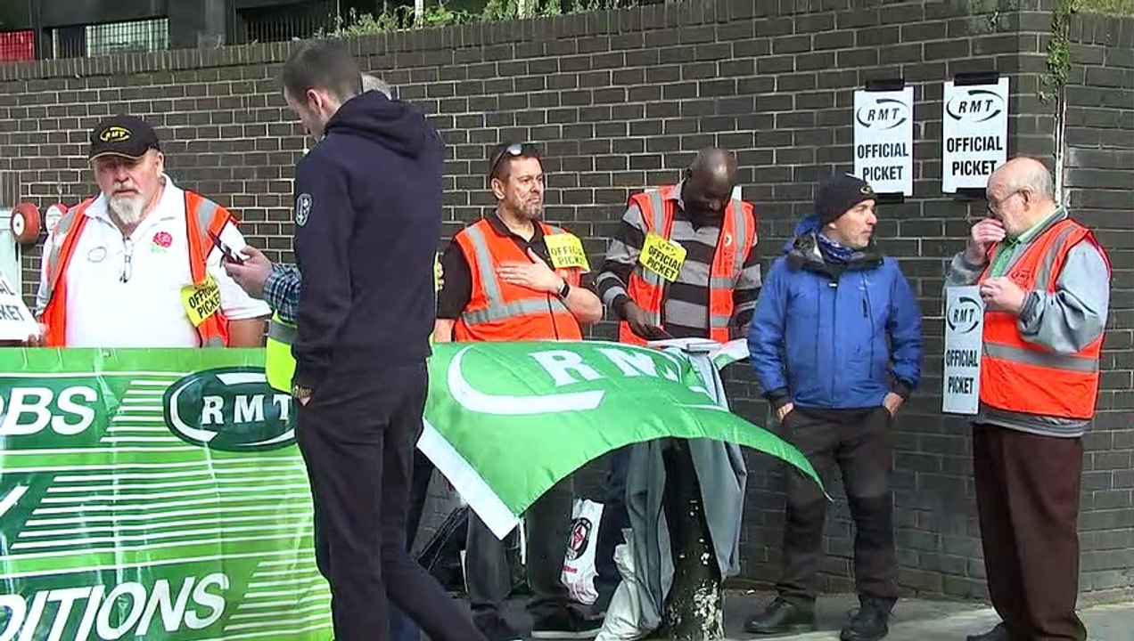 Striking RMT members stand on picket line at Euston Station