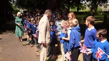 Flag waving school children welcome King and Queen to Wales