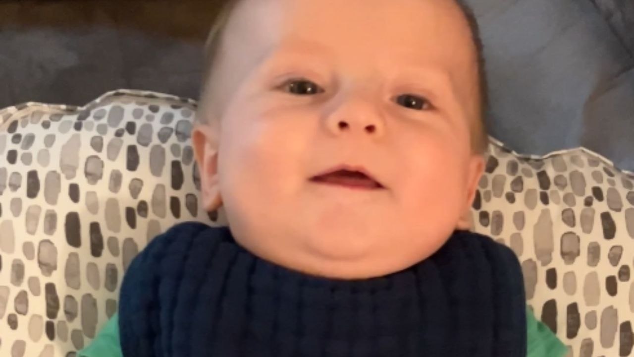 Baby giggles while mother playfully interacts with him *Wholesome moment*