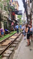 Couple Visit Hanoi's Famous Train Street