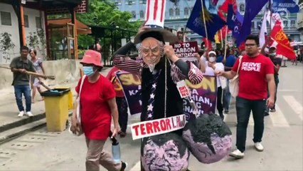 Mascot carries a lato-lato at SONA protest march in Cebu City