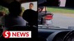 Cops tracking down biker who hit car door with helmet