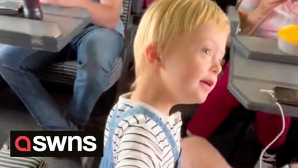 Toddler walks down train aisle to greet every single passenger