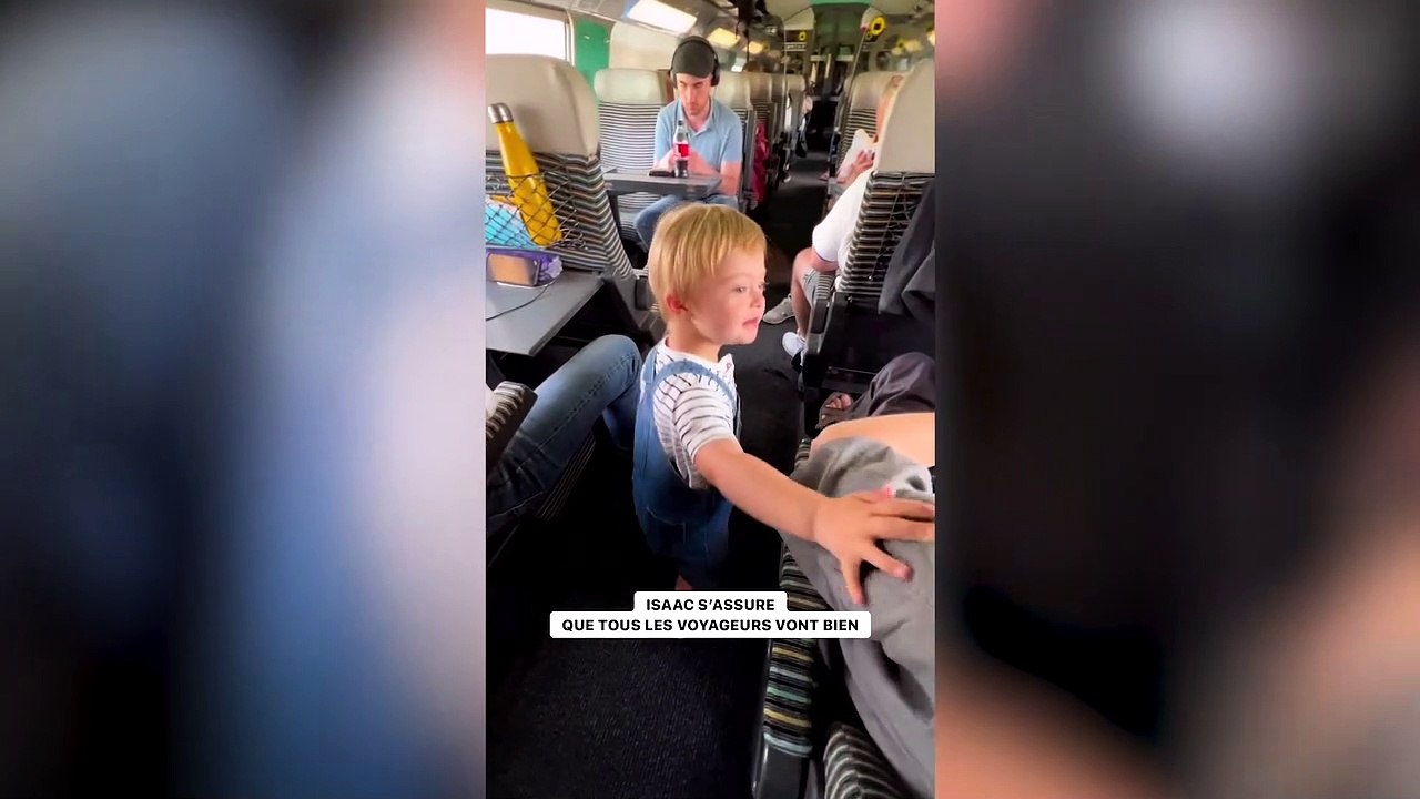 Adorable toddler with Down Syndrome walks down train isle greeting passengers