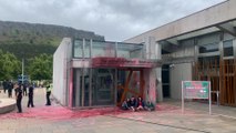 Demonstrators glue themselves to the Scottish Parliament