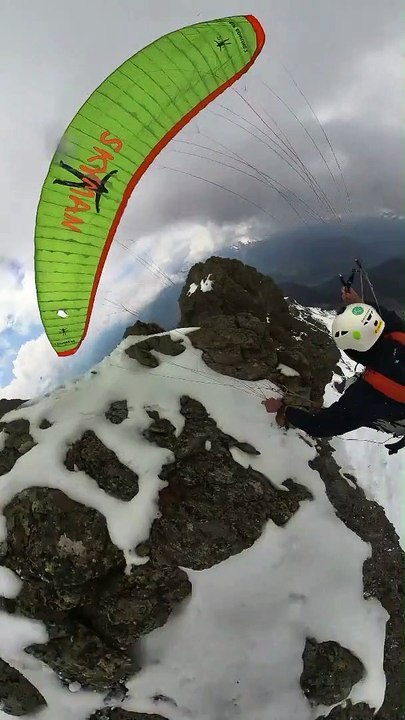Paraglider Catches On Rock