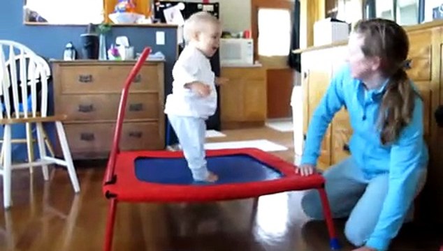 Adorable baby loves jumping on trampoline