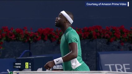 Tiafoe wins first set against Raonic after rare net touch winner