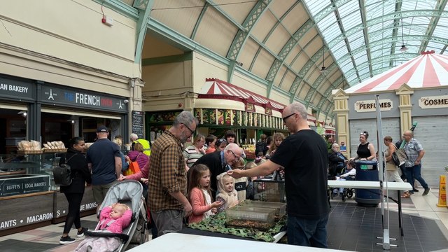 Stall holders discuss summer events in the Grainger Market in Newcastle
