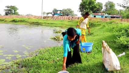 Little beautiful girls are fishing with hooks in the village pond