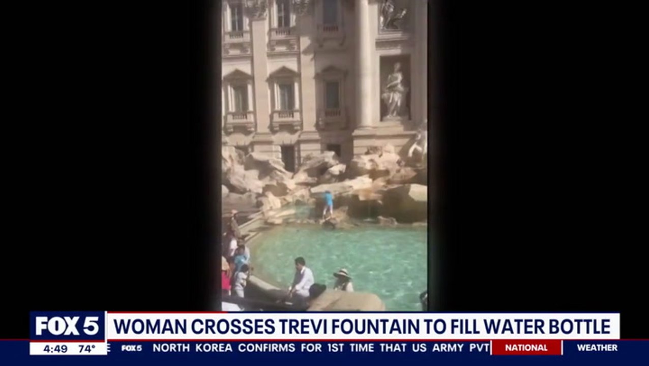Moment Rome tourist scales Trevi Fountain to fill water bottle