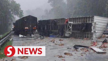 Two killed after trailer crashes through divider near Tapah
