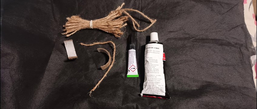 Holding upright a tomato with a daylily dried leaf