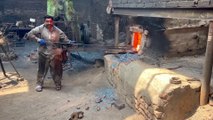 A 55 Year Old Hardworking Man Making Truck Spare Part in  50°C Temperature