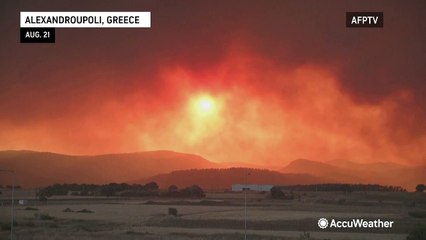 Sunset turns smoke-filled sky orange