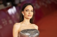 Angelina Jolie has mystery tattoos on both middle fingers, leading fans to speculate that they are against Brad Pitt